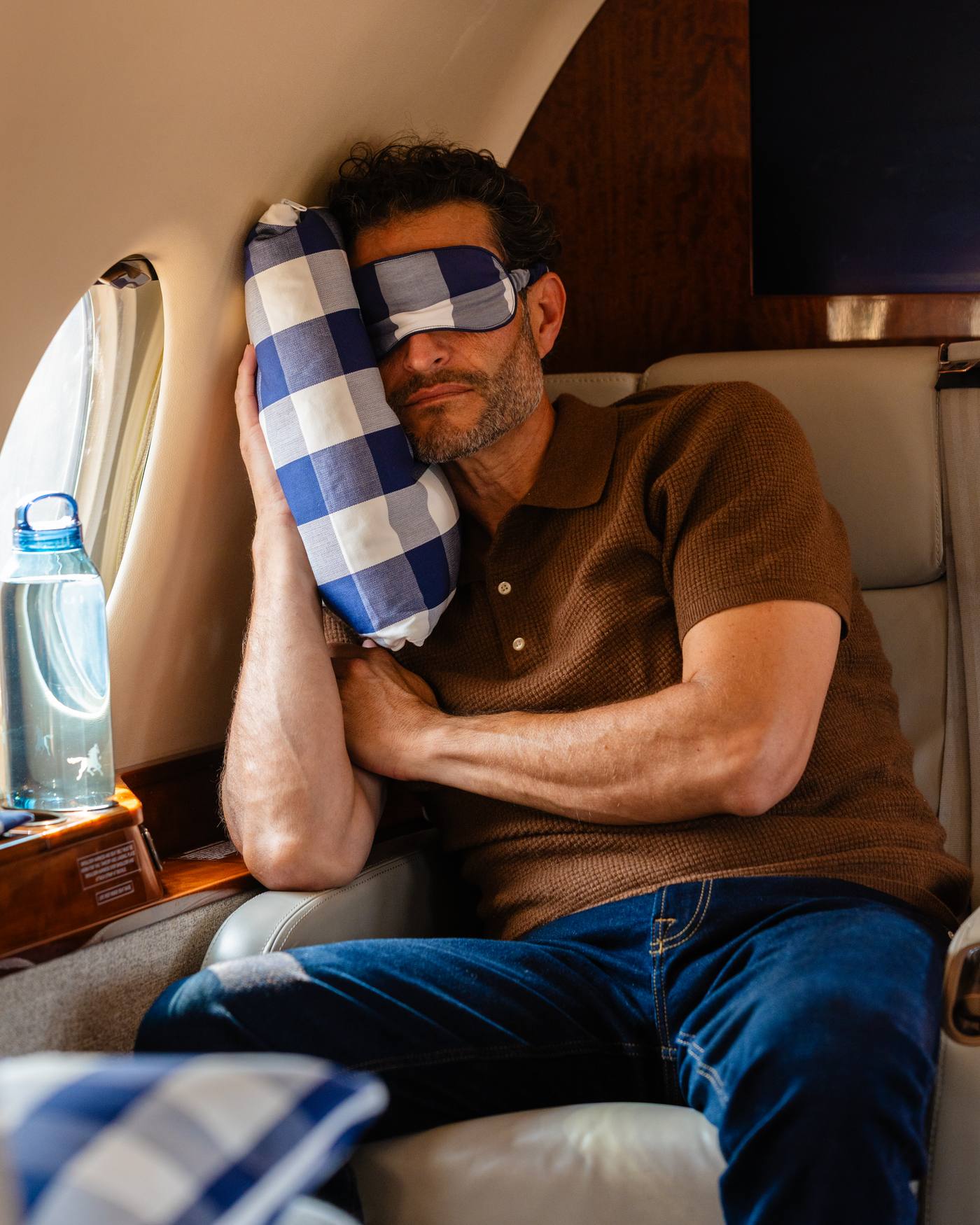 Passenger resting on a Hästens pillow aboard a Helios jet